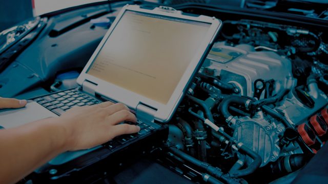 Laptop on top of automotive engine